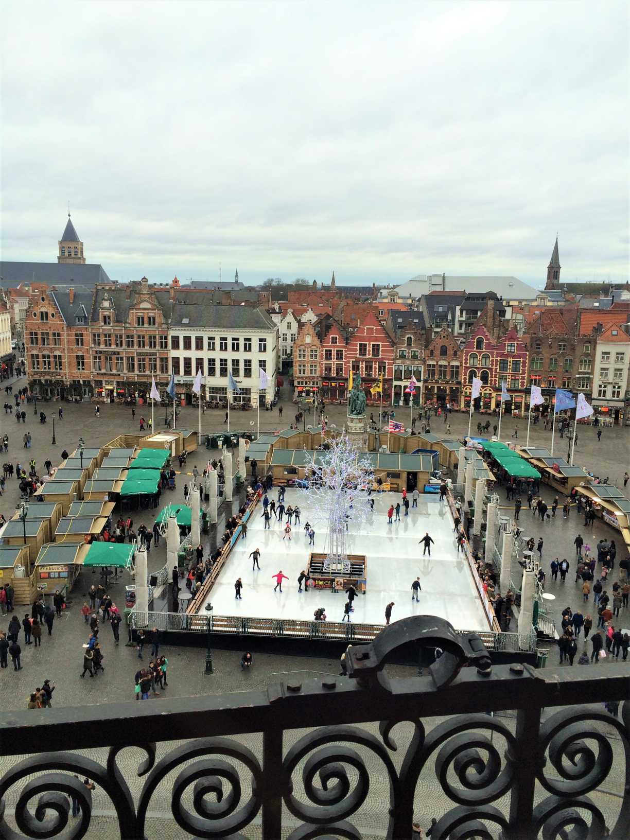 A picture of and ice rink and buildings in Markt in Bruges, Belgium, as seen from the belfry.
