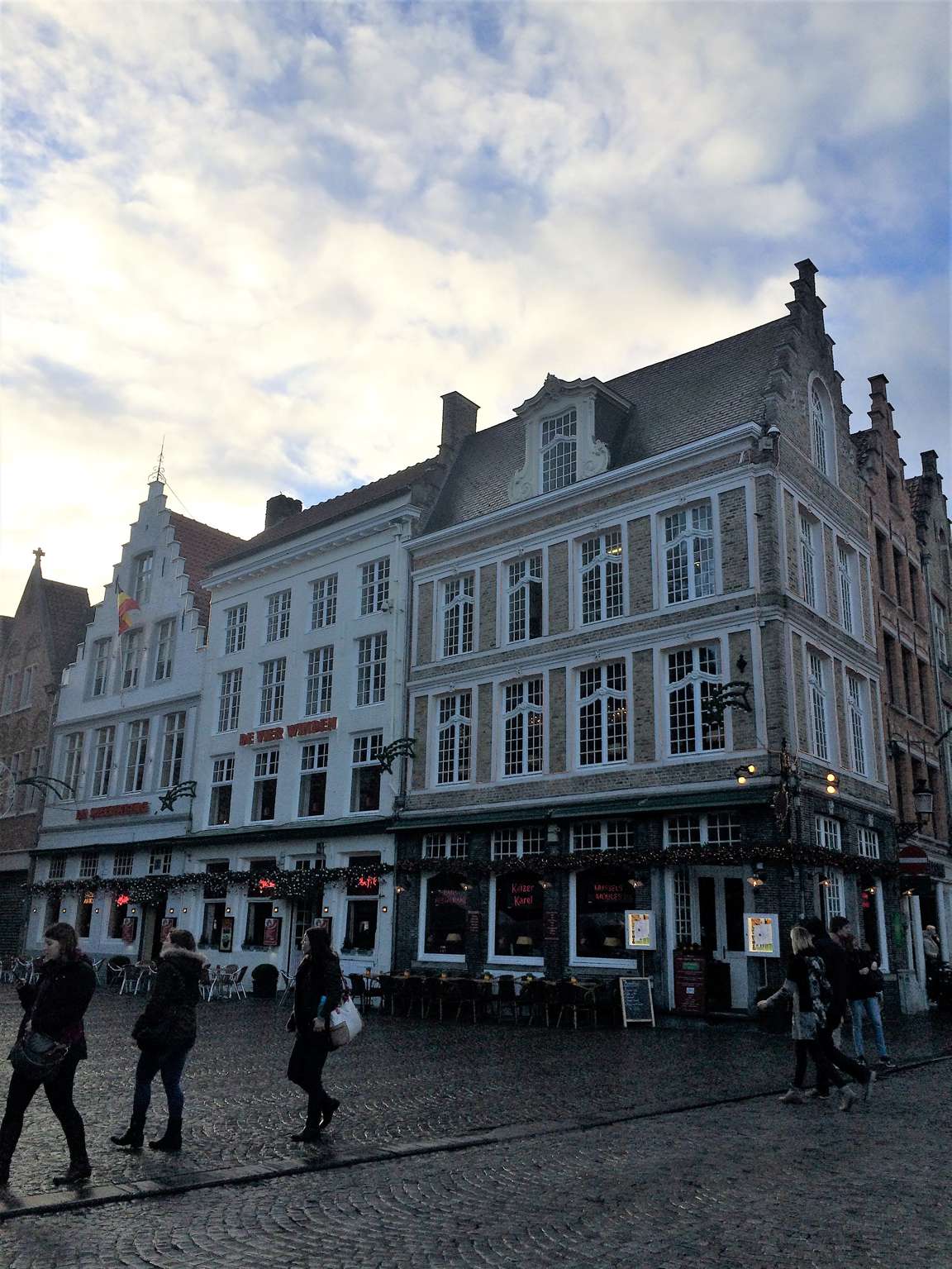 A picture of a street in Bruges, Belgium with gabled buildings and cobblestone streets.