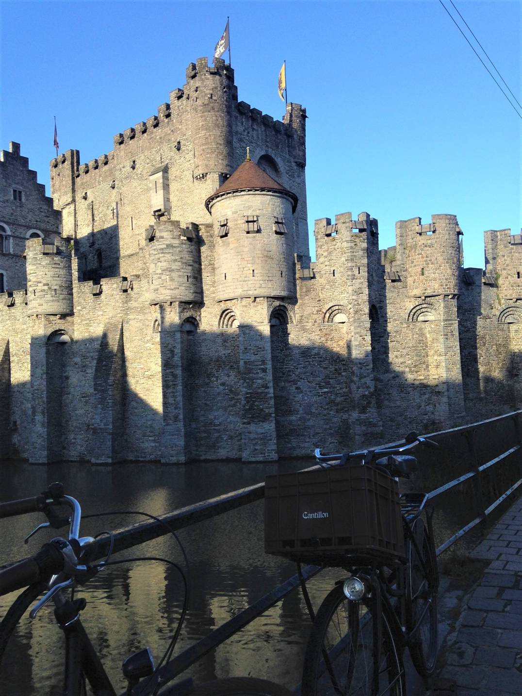 A picture of Gravensteen castle in Ghent, Belgium with a bike in the fore ground.
