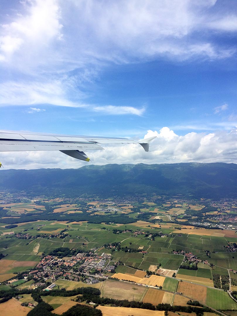 The green countryside and hills of Switzerland as seen from an plane.
