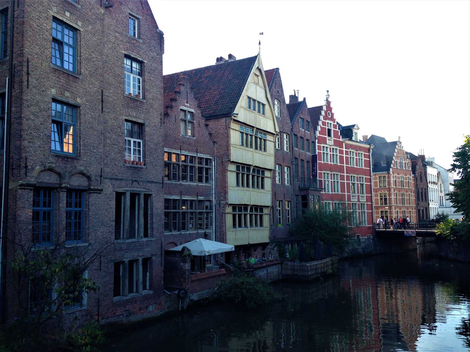 A picture of colorful buildings with gables on a canal in Ghent, Belgium.