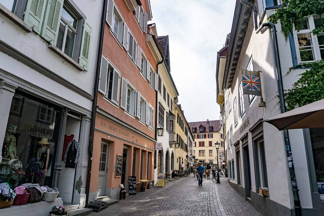 A street in Konstanz, Germany with colorful buildings and a cobblestone street.