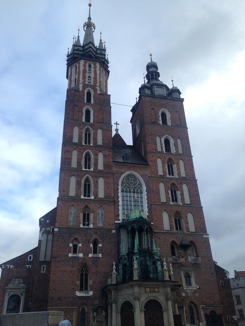 The towers of a brick church in Krakow, Poland.