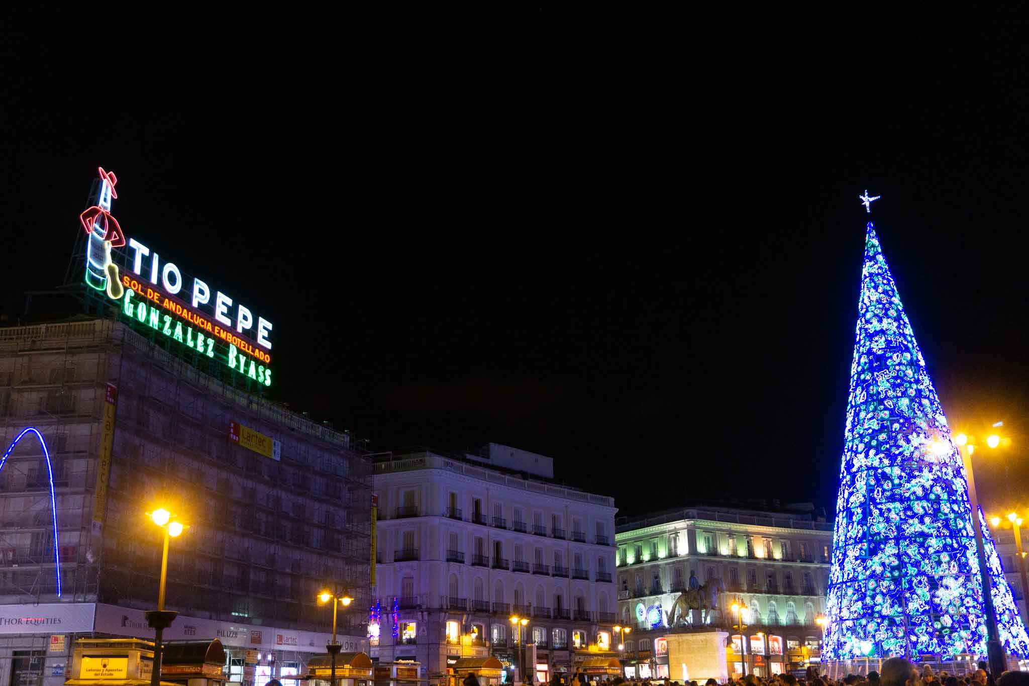 Picture of Puerta del Sol during Christmas in Madrid, Spain with the Tio Pepe sign in the background.