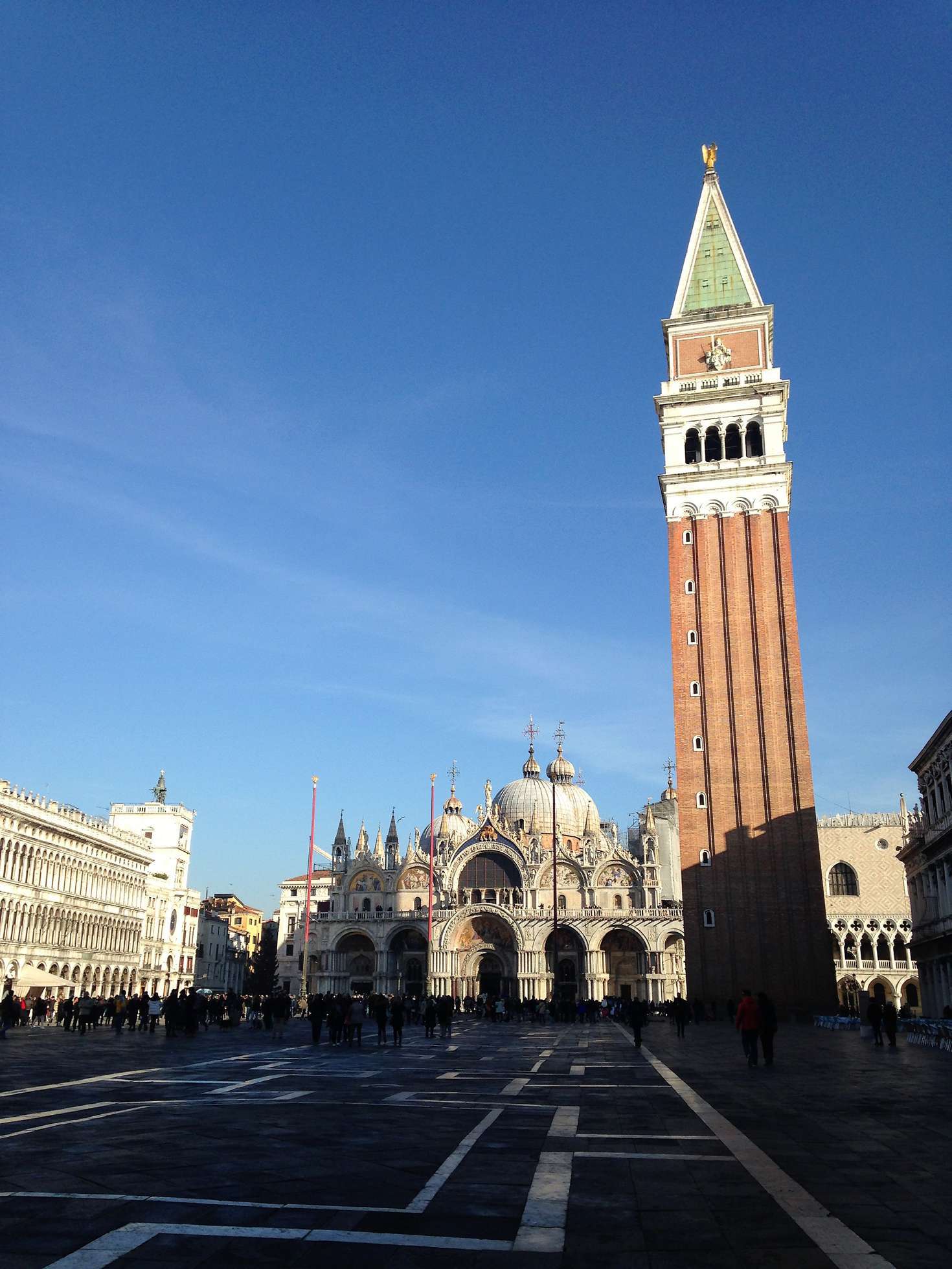 Saint Mark's square with St. Marks's Basilica and a tower in the background.